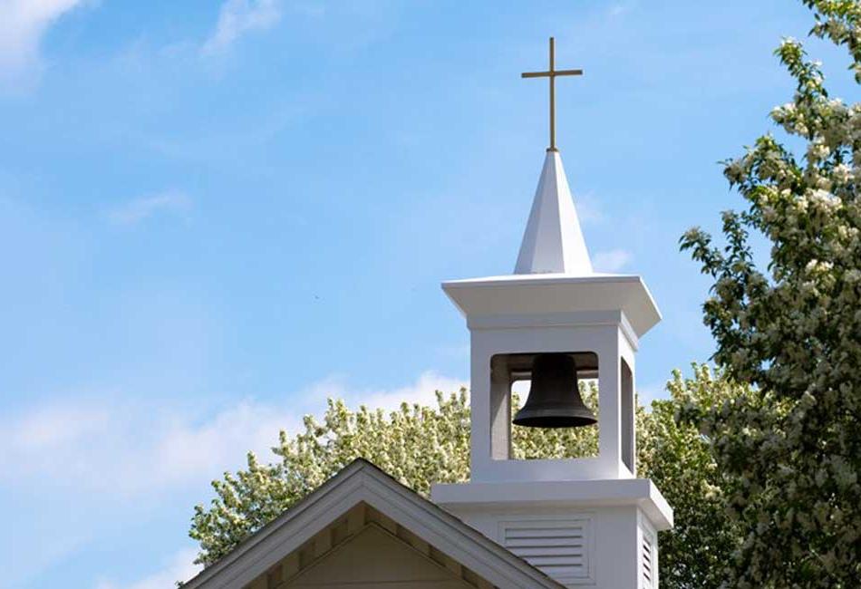 Church steeple with a cross and bell