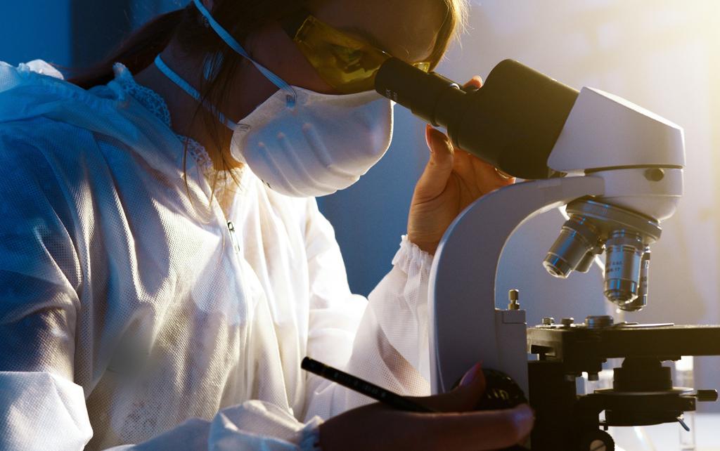 Scientist looking through a microscope